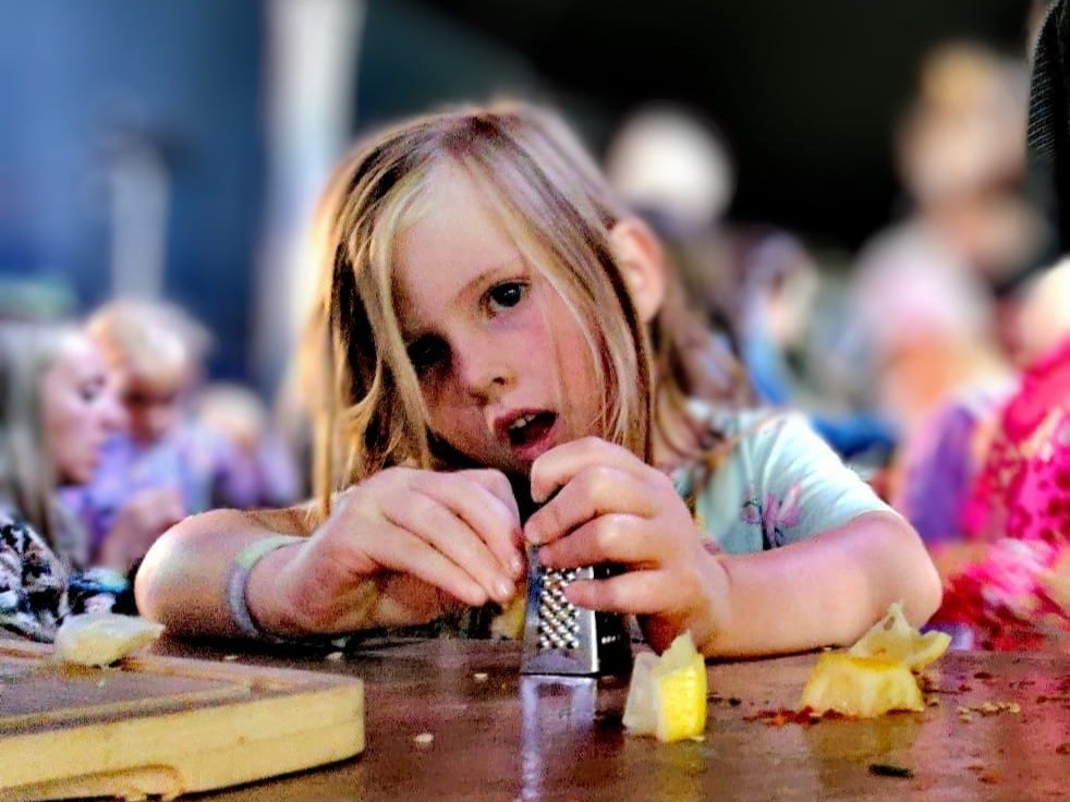 A girl grates lemon in a medicine making workshop